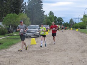 The first set of runners loop through Mayerthorpe heading south on Highway 22 on their way to Highway 43 and the end of the marathon in Whitecourt on Sunday, June 2.