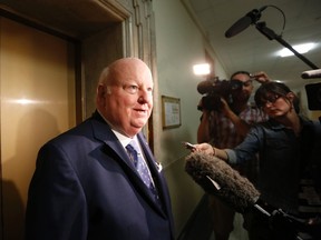 Senator Mike Duffy is questioned by journalists on Parliament Hill in Ottawa May 28, 2013. REUTERS/Chris Wattie