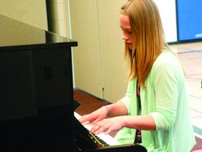 Mikayla Anderson performs a piece at St. Mary’s Catholic school on May 29. Anderson, who’s played the piano for approximately eight years, raised $6,000 to replace the school’s old piano with a new one. (Caryn Ceolin/Peace Country Sun)