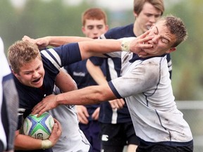 Josh Gingrich-Hadley uses the face of a Strathmore player to push off and gain momentum and Anthony Esponioli in the background.