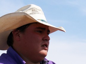 Lane Wolfe waits to be awarded a trophy blanket for winning the team roping competition at the Tour North Ranch rodeo in Fort McMurray on Sunday. ANDREW BATES/TODAY STAFF