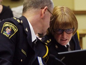 Deputy Chief Paul VandeGraaf and Chief Cory McMullan confer while meeting with Belleville Police Services Board at city hall in Belleville, Ont. Thursday, June 6, 2013. They plan to meet with board and council representatives to examine the police budget approved earlier this year. Luke Hendry/The Intelligencer/QMI Agency