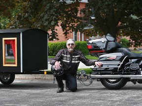 Peter Reed of Owen Sound and his motorcycle hearse, called Everlasting Sunset Hearse Service, outside Tannahill Funeral Home. James Masters photo.