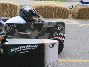 Eric Davidson, back, from Delhi blew the competition away in The Spitfire to win the Legends Soapbox Derby on Saturday during the Springtime in Paris festival with a speed of 40.7 km/h. Here he is racing Hayden Stewart from Paris. PHOTO BY STEVE HOWES