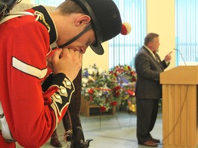 Lance Corporal Graham Casey of the Fort Henry Guard stands watch during Thursday's ceremony to mark the 122nd anniversary of the death of Sir John A. Macdonald as Arthur Milnes addresses the gathering.
Michael Lea The Whig-Standard