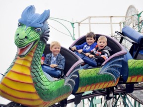 Luke Gallerno, 6, Clark Smyth, 5 and Ayden Caron, 5, far right, prepare for the first drop on the mini-roller-coaster at the 68th annual Kinsmen Fair in Chatham, On., Thursday, June 06, 2013. The fair will be in town until Sunday. Photo Taken Chatham, On., Thursday June 6 2013 DIANA MARTIN/ THE CHATHAM DAILY NEWS/ QMI AGENCY