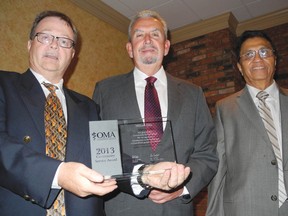 Milton Ellis, centre, was awarded the Ontario Medical Association Community Award for his involvement in several charitable organizations and efforts over the years. Presenting the award were (left) Cornwall Academy of Medicine president Dr. Garrett Foley and Dr. Nat Shah.