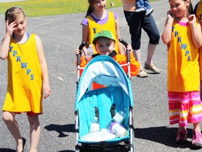 Five-year-old cancer survivor Kyle Lecuyer helped lead a victory lap around the Roland Michener Secondary School track on Thursday. Here, he is surrounded by new friends from Frank P. Krznaric Whitney Public School, who took part in the fundraising event at RMSS. Local schools and students honoured cancer survivors and raised money for Kyle's Krew, a fundraising team taking part in Relay for Life on June 14 at O’Gorman High School.