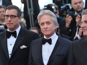Michael Douglas (C) poses with screenwriter Richard LaGravenese (L) and writer Scott Thorson. (ALBERTO PIZZOLI/AFP)