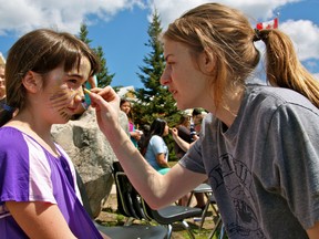 Grade 4 student Katie Scutt gets her face painted by volunteer Shelayna Loranger at the St. Thomas Aquinas Street Fest on Thursday.
MARNEY BLUNT/Daily Miner and News