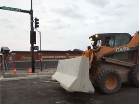 Forklift operator Dale Connell removed the last of the barricades blocking access to the Centre Avenue main artery through the new Quarry retail district. Traffic lights have now been activated on both Railway and Griffin.
