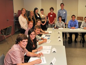 Participants in this year's Summer Company program pose at the Laurier Boulevard firehall on Thursday. From front left are Lucas Rayvals, Sarah VanAsseldonk, Luke Carroll, Mitchell Beattie, Janine Steyn (standing), Krystal Dancy (seated), Mariah Bourguignon (standing), Brittani Service, Emily Morris, Jacob Elliott, Tylor Brenneman (seated), Charles James (standing behind Tylor), Bradley Loker and Austin Hardy. Absent from the photo is Claire McFarlane.RONALD ZAJAC The Recorder and Times