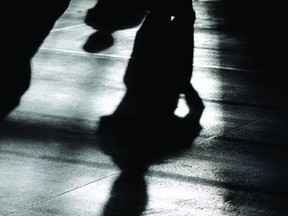 Cadets at attention form silhouettes on the floor of the Brockville Armouries.