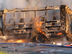 A school bus driver and the driver of a minivan are dead after a fiery crash Frida, July  7, 2013, in northern Ontario. Police say the vehicles collided just after 5 a.m. at the junctions of Highway 101 and Highway 144, near Timmins. Both the bus and van were destroyed by fire before emergency responders arrived on the scene. (Len Gillis, QMI Agency)