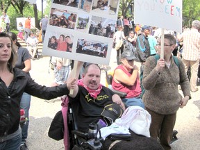 A client of Rehoboth Christian Ministries in Stony Plain protests funding cuts to the persons with developmental disabilities at the provincial legislature on May 31. - Photo Submitted