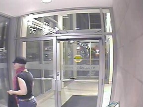 Police are seeking the public's help in identifying this woman, seen in surveillance footage from the CIBC at the Kingston Centre, where a suspicious package resulted in the OPP bomb sqaud being called in Tuesday morning.