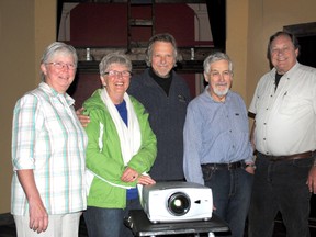 Photo by Amber Van Wort For The Intelligencer
Shown here at a presentation this week are, from left, chair of Tweed and Area Arts Council Bonnie Marentette, Roely DeVries, John Wilson, Don Herbertson and Wayne Kay in front of the film projection equipment donated by John Wilson and wife Denice Wilkins.