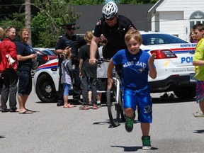 M.T. Davidson students race against North Bay Police Service Const. John Cook's patrol bicycle, during the school’s ‘bring your parent to lunch day’ this week.