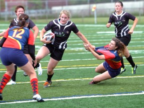 A Kent Havoc defender hangs off Sarnia Saint Daria Keane's arm as Keane breaks for the goal line in the Saints' 39-12 win Saturday at Norm Perry Park in Sarnia, Ont. Keane would go on to score a try on the play. PAUL OWEN/THE OBSERVER/QMI AGENCY