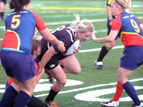 Daria Keane, centre, of the Sarnia Saints powers through the Kent Havoc defence in the second half of the Saints' 39-12 win Saturday at Norm Perry Park in Sarnia, Ont. PAUL OWEN/THE OBSERVER/QMI AGENCY