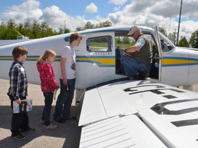 Siblings, from left, Alex Whaley, 12, Allison Whaley, 10, and Taylor Whaley, 15, from Meaford listen as pilot Doug Monroe gives them instructions prior to boarding his Beech Musketeer at the Owen Sound Billy Bishop Regional Airport on Saturday. The youth were taking part in the COPA for KIDS event, where youth age 8 to 17 had a chance to go for a 20 to 25 minute flight with local pilots. About 150 youth participated in the event. (Rob Gowan The Sun Times)