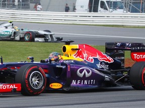 Red Bull driver Sebastian Vettel (front) drives ahead of Mercedes driver Lewis Hamilton during the Canadian Grand Prix at the Circuit Gilles Villeneuve in Montreal, June 9, 2013. (REUTERS/Christinne Muschi)