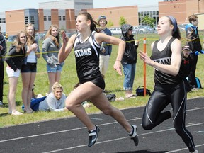 QMI File Photo
Holy Trinity's Celina DeCarolis (left) is seen here with Hannah Reardon racing down to the wire in the senior girls 100m dash during last year's NSSAA track and field event. DeCarolis won gold at the 2013 OFSAA track and field championships over the weekend in the senior girls long jump event.