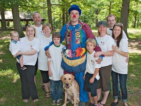 Marc Proulx, also known as Marco the Clown, is surrounded by Walsh family members (from left) one-year-old Bentley Bowen and his mother, Chrissy Walsh, Steve Greenaway, Jeannette Walsh, Ethan and Ian Clark, Raquel Clark, Nathan Kershaw and Katelyn Walsh.  Proulx and the Walsh family are carrying on the annual Jim Walsh Bike Rides, which help raise funds for Help A Child Smile, Sick Kids Hospital in Toronto and other charities.  Walsh lost his battle to cancer in September 2012. (Brian Thompson, The Expositor)