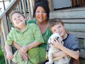 Stephanie Hill holds her sons, Connor Jones (left), 6, and eight-year-old Lucas Jones, who was diagnosed with cystic fibrosis when he was born. To deal with his disease, Lucas keeps active, takes a lot of medication and is careful about his environment. (Vincent Ball, The Expositor)