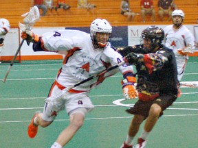 Six Nations Arrows' Shane Simpson of the Six Nations Arrows runs past Whitby Warriors' Matt Hossack of the Whitby Warriors on Sunday in Ontario Junior A Lacrosse League action at the Iroquois Lacrosse Arena. (DARRYL G. SMART, The Expositor)