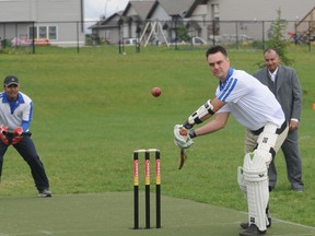 Mayor Bill Given suited up and took a turn as batsman to officially open the new Grande Prairie Cricket Association pitch in Northridge Park June 8, 2013 in Grande Prairie, Alberta, while Devendera Saindane (left) and Rajinder Prashar watch in anticipation of a hit.
DIANA RINNE/DAILY HERALD-TRIBUNE/QMI AGENCY