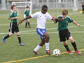 Frank Atoh, a native of Cameroon, makes a play for the ball during soccer action Saturday at Omischl. Atoh travels from Sudbury to play and practice with the North Bay Selects F.C. Atoh scored the Select's only goal in Saturday's game against Etobicoke. The teams tied 1-1.