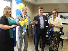 Office manager Shannon Huggins opened Queensview Retirement Community on King Edward Street in Paris on Thursday, May 30, 2013 with the help of Brant Mayor Ron Eddy, Nautical Lands Group CEO Kirk Hoppner and Queensview wellness coordinator RuthAnn Wassing. MICHAEL PEELING/The Paris Star/QMI Agency