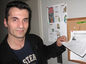 Muhamet Bajraktari looks at the signatures that have already been collected on a petition, placed on a bulletin board in the apartment building he lives in, which calls on the Canadian government to reverse a deportation order against him and his Ganimete Berisha and their four-year-old daughter Eliza Bajrakarti, who was born in Chatham, Ont. Photo taken Friday, June 7, 2012, in Chatham, Ont.
(ELLWOOD SHREVE, Chatham Daily News)