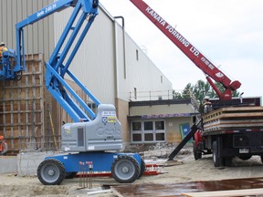 Workers prepare a form at the north end of Memorial Gardens, Monday, June 10, 2013. The $12-million renovation is expected to be substantially completed by Oct. 11, the date of the first North Bay Battalion home game.