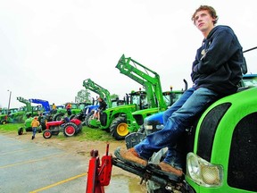 Gys Bertens joins fellow Stratford St. Michael Catholic Secondary School students Monday for Tractor Day, where some 20 John Deere, Case and New Holland farm vehicles were driven to school in a show of rural pride. (MIKE BEITZ, The Beacon Herald)