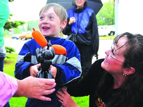 Odin Monk, 5, and his mother, Caroline receive a balloon dog at Grande Prairie Municipal Government Day last year. The balloon animals will once again be a popular item during this year’s event, slated for Wednesday at Muskoseepi Park. (DHT FIle Photo)
