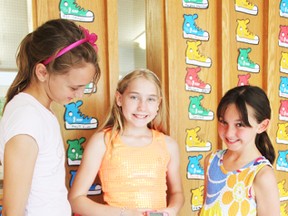 Brooke Beuermann shows her insulin pump to friends after a school-wide assembly at Seaforth Public School about Juvenile Diabetes.