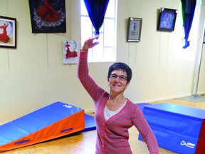 Debbie Donaldson, co-founder of Dreams in Motion, strikes a pose in the auditorium of her studio. Donaldson will retire this month after 30 years of teaching dance.                Wayne Lowrie - Gananoque Reporter