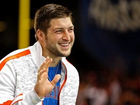 Former Florida Gators quarterback Tim Tebow waves as he stands on the sidelines before the Gators play against the Louisville Cardinals in the 2013 Allstate Sugar Bowl NCAA football game in January. (REUTERS/Jonathan Bachman/Files)