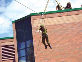 Pte Patrick Wall makes a zip line descent from the roof of the armoury at the 116th Independent Field Battery, Saturday, June 8.
MBdr Lynn Danielson/HANDOUT