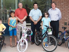 Five lucky kids received a special surprise courtesy of the North Eastern Ontario Family and Children’s Services (NEOFACS) in the form of brand new bikes. The bikes were prizes from a contest run during Children’s Mental Health Week. On hand for the presentation were:back row, from left,  Robert Perrault, Michael Kerr and Richard Lambert-Bélanger; and front row, Logan Bechard-Jetté, Liberty Blueboy, Mackenzie Bélanger and Kody Boucher.