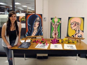 CHSS Grade 12 art student Raquel Woodliffe next to her body art inspired paintings at the senior art show Friday.
