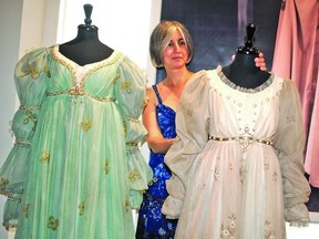 Francesca Marini, Stratford Festival archives director, is shown here with, at left, a dress worn by Frances Hyland as Portia in 1955 and a dress worn by Julie Harris in 1960 when she played Juliet. Both dresses were designed by the famous Tanya Moiseiwitsch and can be viewed up close at the Exhibition located across the street from The Avon Theatre. (LAURA CUDWORTH, The Beacon Herald)