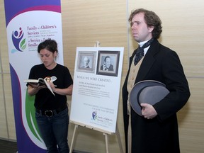 Actor Matthew Donovan playing Sir John A Macdonald, listens as Anna Sudac reads from a book about Sir John's tragic private life at a video launching at the Family and Children's Services office on Tuesday.
Ian MacAlpine The Whig-Standard