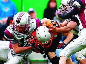 Newmarket’s Dean Agha (23) tries to break a Grenadier tackle with Ben Maracle (12) on his back during the Bantam Grenadiers season opener.      ERIC HEALEY - KINGSTON THIS WEEK