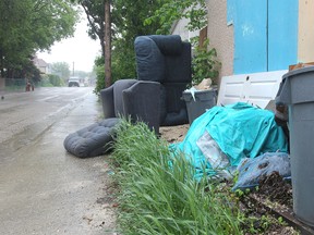 Garbage and other items left piled in lanes, as seen on Prince Edward Street in Point Douglas on May 31, 2013, can often lead to arsons. A city report says the number of arsons has more than doubled in the past six years while arrests have dwindled. (KEVIN KING/Winnipeg Sun)