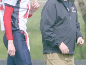 Logan Clow/R-G
The Peace River Pioneers held a Spring Jamboree at Glenmary Field on Wednesday, June 5, 2013. Pictured: Pioneers Quarterback Jacob Southwick (left) listens in to instructions from the new Pioneers Head Coach Hayden Gust.