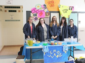 Grade 9 students from Queen Elizabeth Jr. High School show off their lemonade stands, which were part of a creative idea to teach students how to market and compete with other businesses in a competitive marketplace.