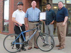 Timmins Mayor Tom Laughren formally announced next Wednesday, Thursday and Friday as a city-wide IM IN to Biking Week. The event encourages residents to ditch their vehicles for their bicycles, enjoying all of the perks of physical activity along the way. From left are Marty Paul, Laughren, Willy Metat and Andrew Marks.